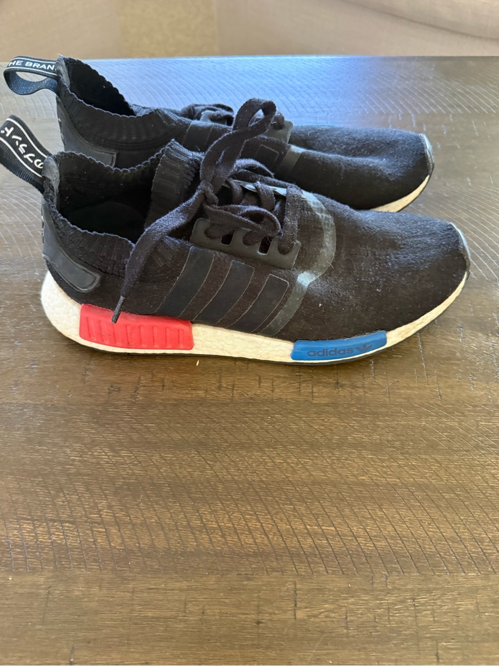 Adidas NMD R1 Black Knit Sneakers with Red & Blue Midsole Accents